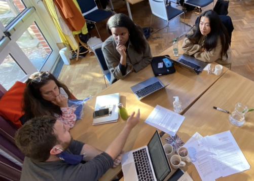 Masters students collaborating around a table