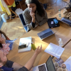 Masters students collaborating around a table